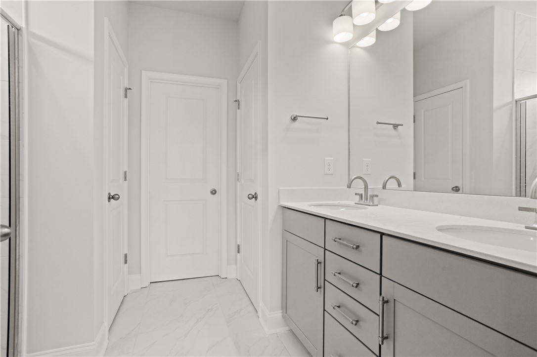 554 Hydrangea Street, Unit LOT 67 Seneca, SC 29678 - Photo 14 of 26 Dual vanity with undermount sinks and modern fixtures elevate this contemporary bathroom space.