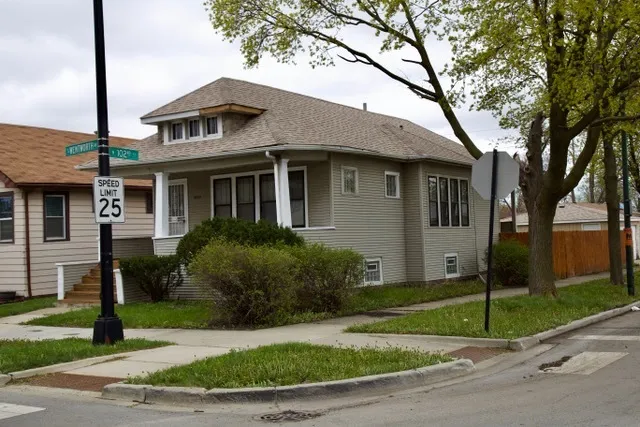 a front view of a house with a garden