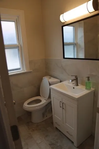 a bathroom with a sink toilet and mirror