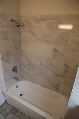 a bathroom with a bathtub and a shower