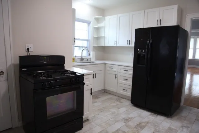 a kitchen with a refrigerator stove and cabinets