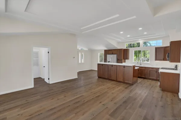 a open kitchen with stainless steel appliances kitchen island wooden floors and center island