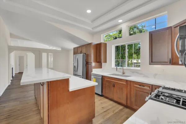 a kitchen with stainless steel appliances granite countertop a sink stove and refrigerator