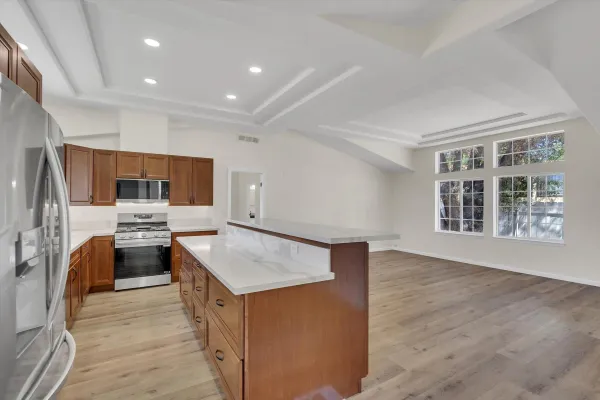 a kitchen with refrigerator and cabinets