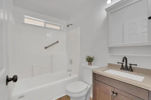 a bathroom with a sink a toilet and a bathtub
