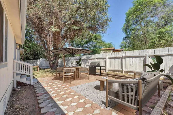 a view of a patio with a dining table and chairs