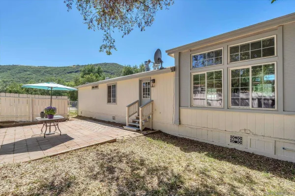 a view of a backyard with sitting area