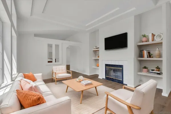 a living room with furniture a fireplace and a flat screen tv