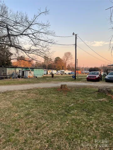 a view of a yard with a car parked in it