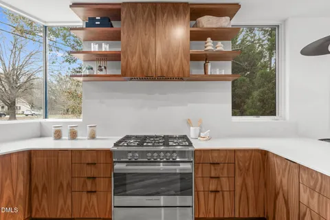 a kitchen with stainless steel appliances a stove and a cabinets