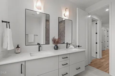 a bathroom with double sink and a mirror