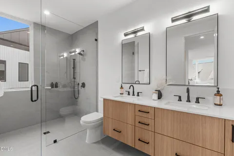 a bathroom with a toilet sink shower and mirror