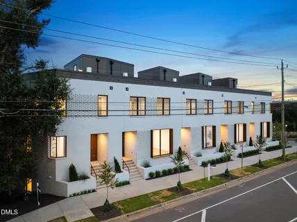 a front view of a residential apartment building with a yard