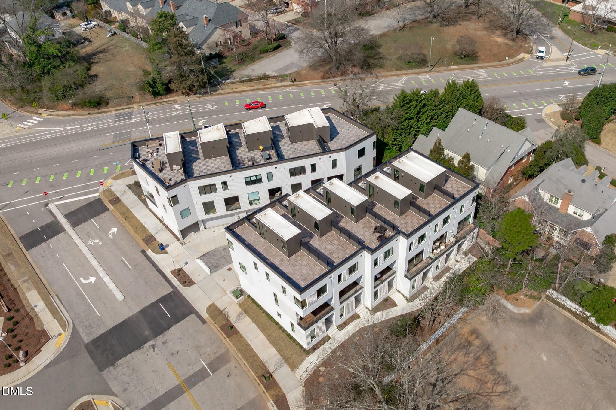 1307 Chamblee Hl Court Raleigh, NC 27608 - Photo 45 of 56 an aerial view of a multi story parking building with yard and mountain view in back