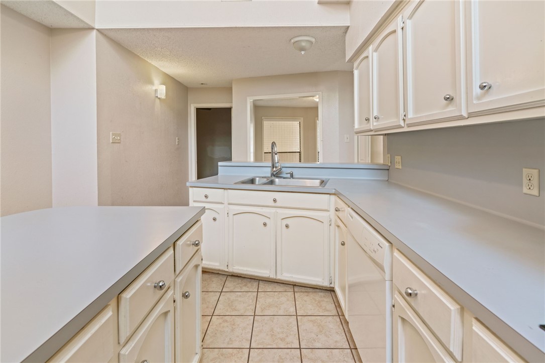 7209 Candy Ridge Road Corpus Christi, TX 78413 - Photo 9 of 24 a kitchen with white cabinets appliances and sink