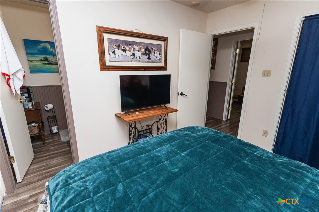 802 Bay Street Austwell, TX 77950 - Photo 18 of 27 a bedroom with a bed and a flat screen tv