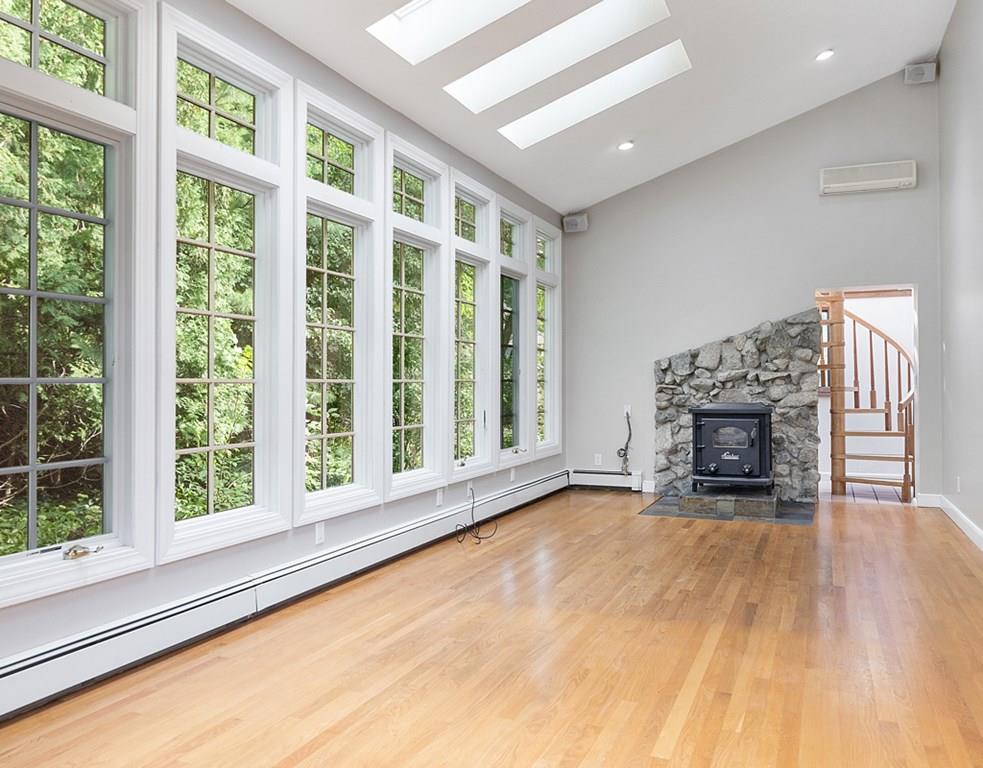 9 Northgate Road Wellesley, MA 02481 - Photo 3 of 32 a view of an empty room with a fireplace and a window