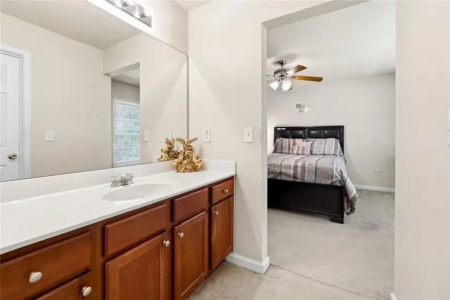 a en suite bathroom with a double vanity sink and a mirror