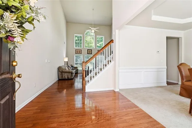 a view of entryway and hall with wooden floor