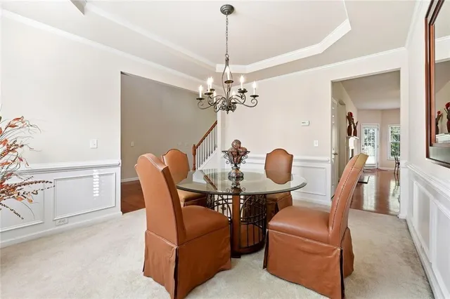 a dining room with furniture and chandelier