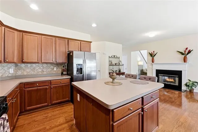 a kitchen with a sink a stove a refrigerator and white cabinets