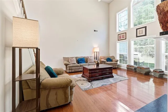 a living room with furniture wooden floor and a large window