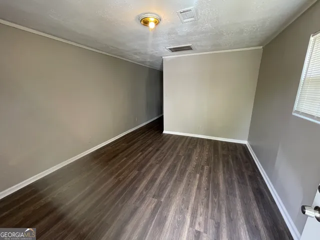 a view of a room with wooden floor