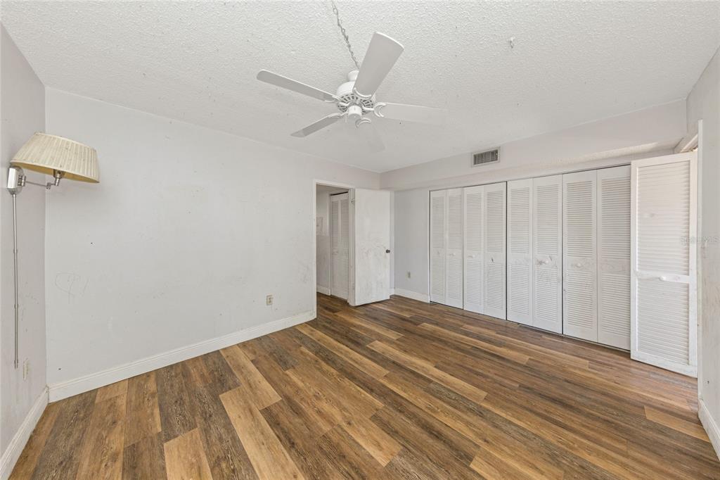 10032 65th Avenue North, Unit 9 St. Petersburg, FL 33708 - Photo 12 of 18 a view of a livingroom with wooden floor and a ceiling fan