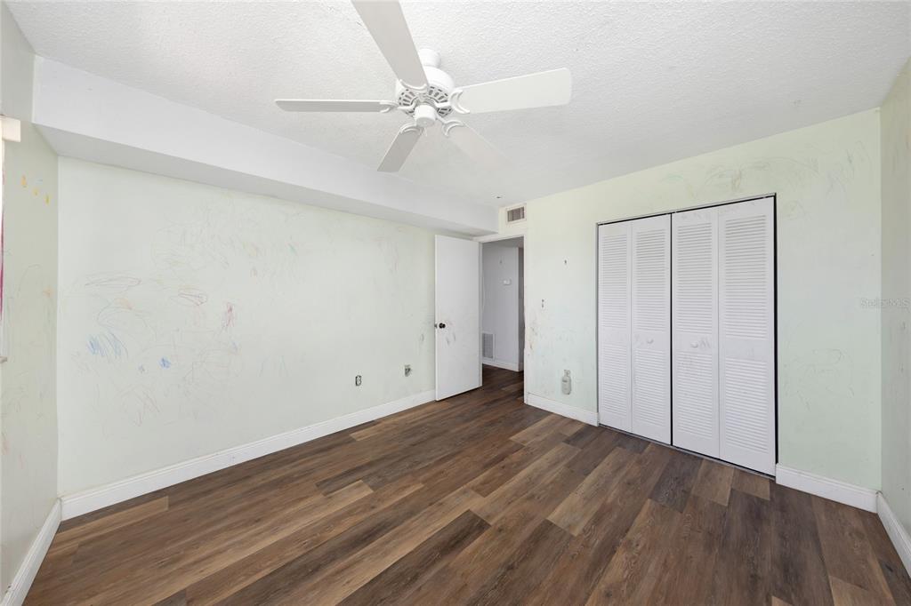 10032 65th Avenue North, Unit 9 St. Petersburg, FL 33708 - Photo 15 of 18 a view of an empty room with wooden floor