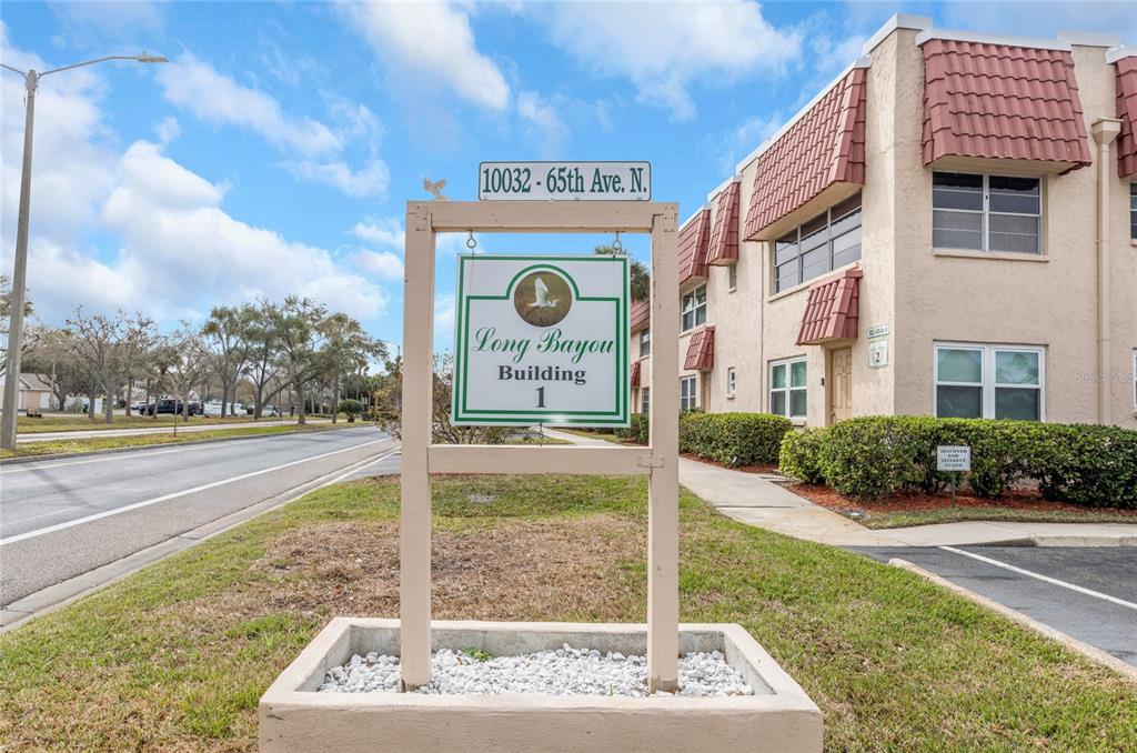 10032 65th Avenue North, Unit 9 St. Petersburg, FL 33708 - Photo 18 of 18 a front view of a building with garden