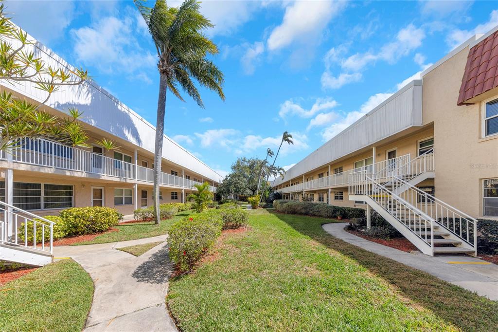 10032 65th Avenue North, Unit 9 St. Petersburg, FL 33708 - Photo 2 of 18 a view of a house with a yard