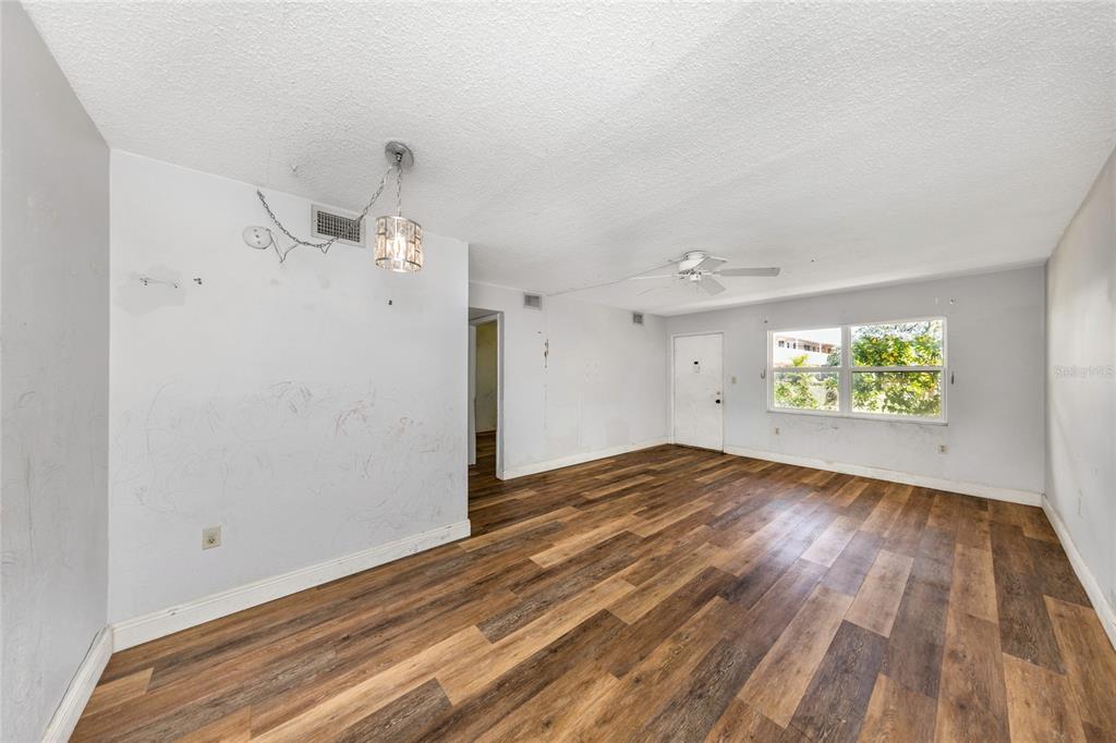 10032 65th Avenue North, Unit 9 St. Petersburg, FL 33708 - Photo 5 of 18 wooden floor in an empty room with a window