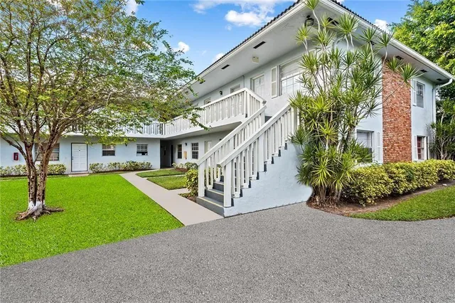 a view of a house with a yard and plants