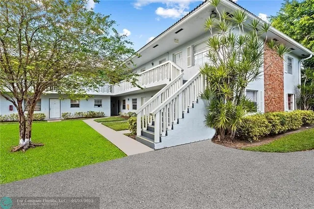 a view of a house with a yard and plants