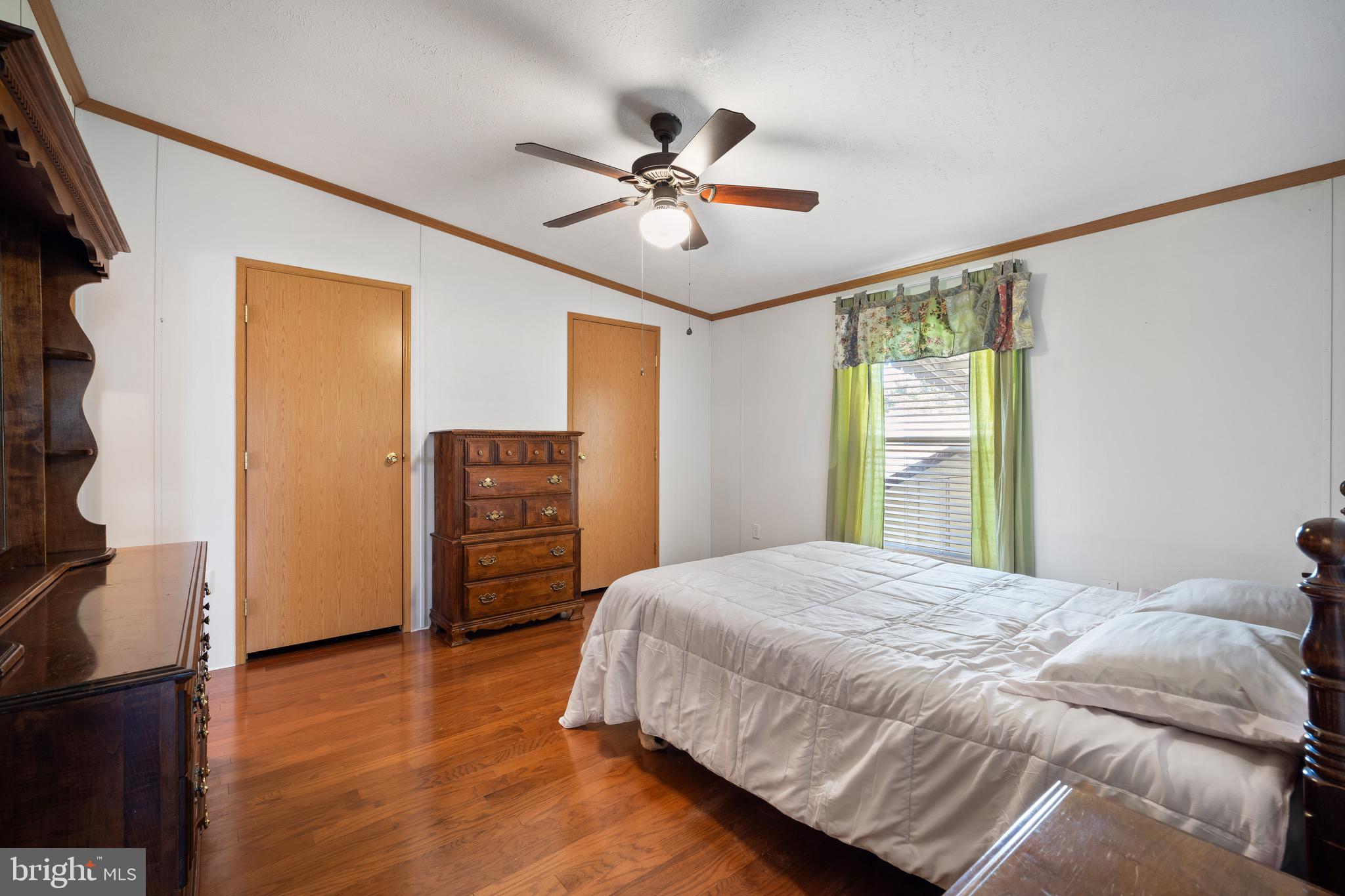 29 Oak Drive, Unit D Sicklerville, NJ 08081 - Photo 14 of 23 a bedroom with a bed and a chandelier