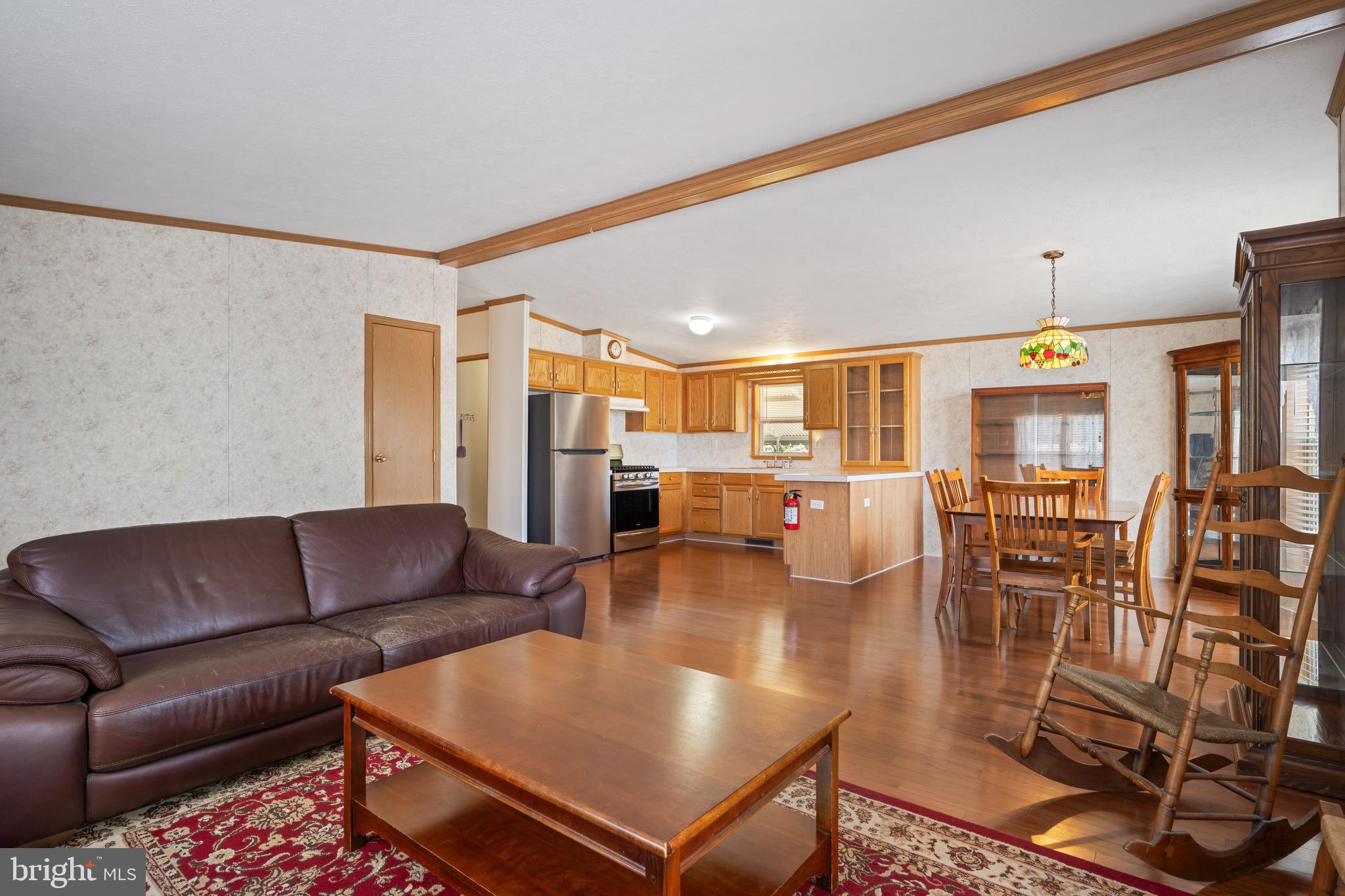 29 Oak Drive, Unit D Sicklerville, NJ 08081 - Photo 5 of 23 a living room with furniture kitchen view and a chandelier