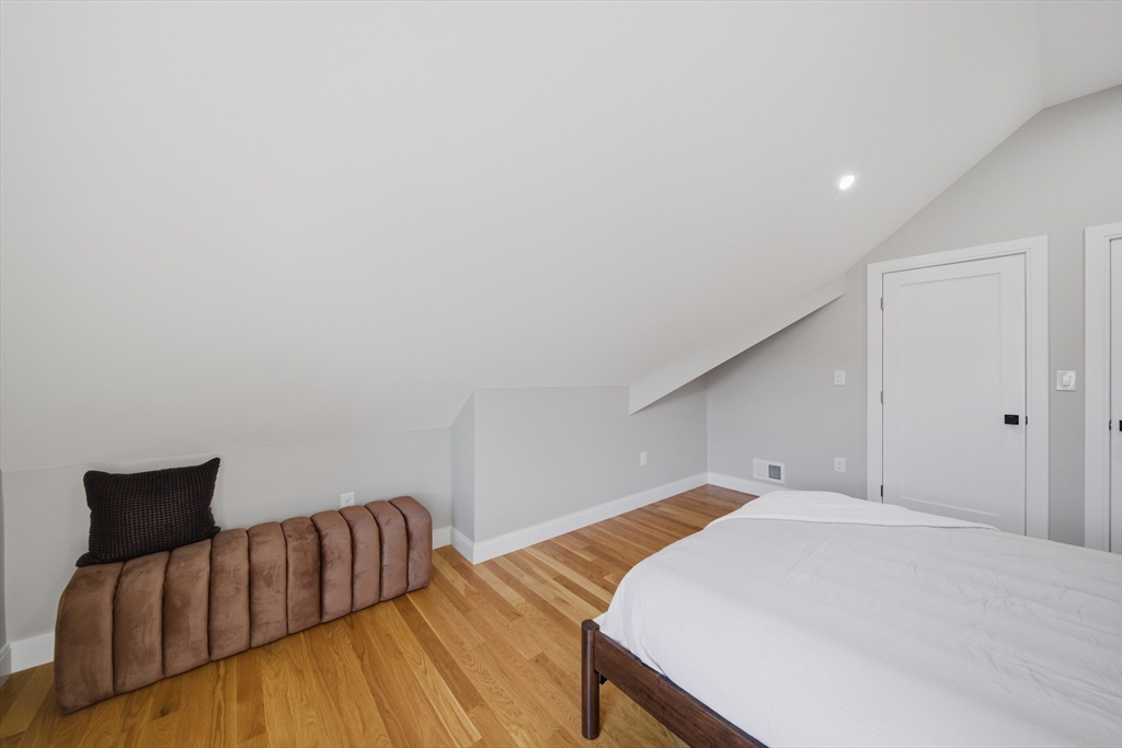 174 Walnut Street, Unit 3 Somerville, MA 02145 - Photo 20 of 38 a bedroom with a bed and wooden floor