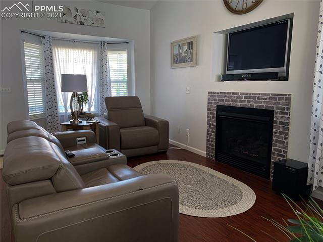 7501 Farmcrest Road Colorado Springs, CO 80925 - Photo 2 of 13 Gas fireplace with a bay window to enjoy evenings