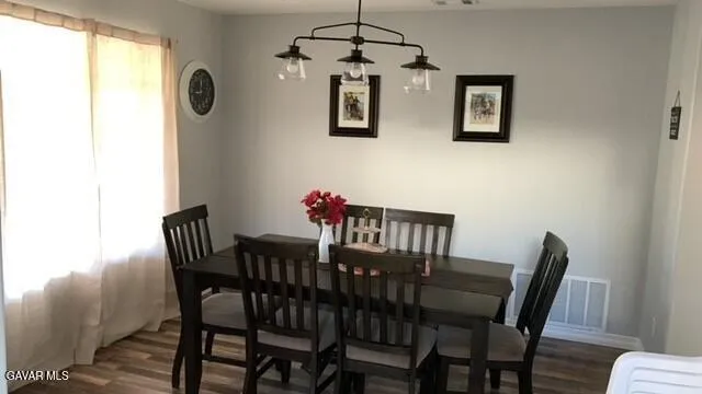 a view of a dining room with furniture and window