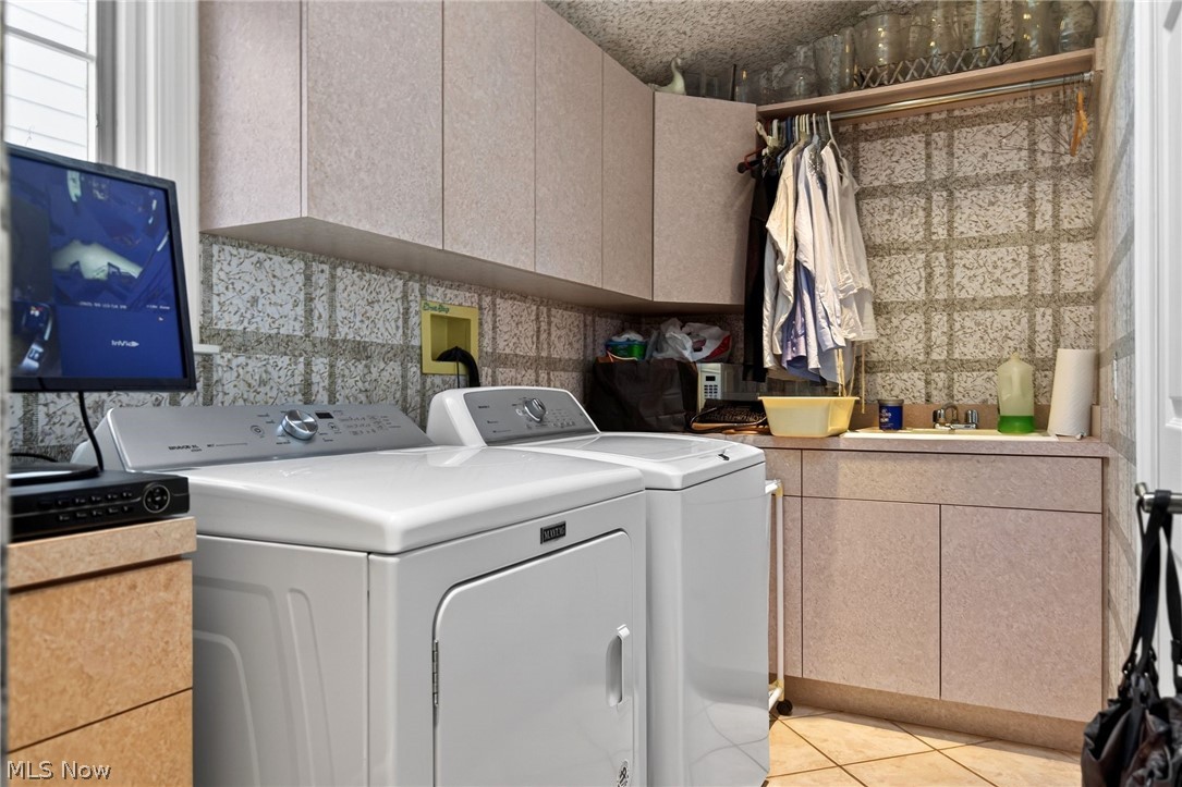 3498 Bainbridge Road Cleveland Heights, OH 44118 - Photo 25 of 50 Washroom with cabinet space, independent washer and dryer, and light tile patterned floors