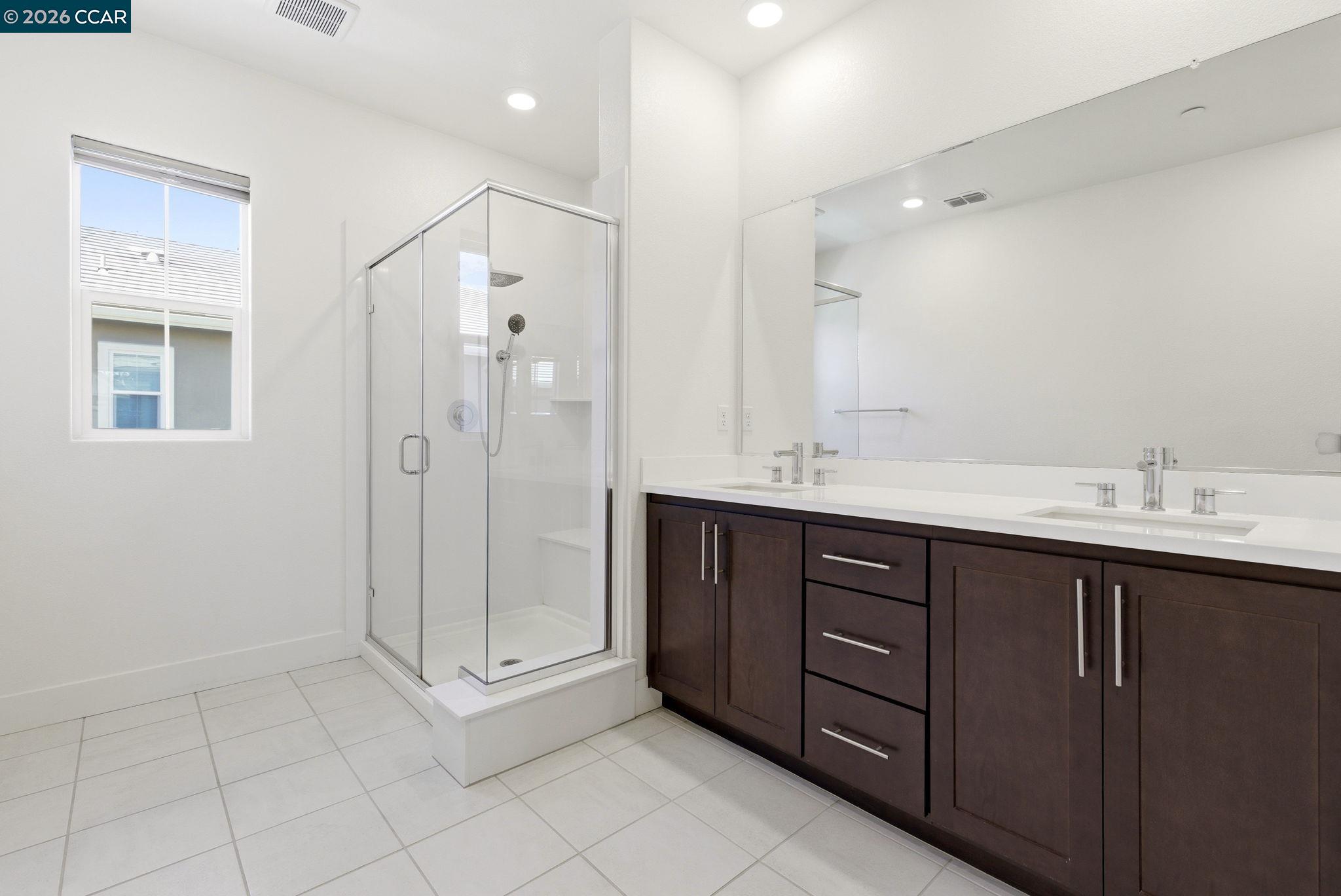 205 Plum Tree Street Livermore, CA 94551 - Photo 29 of 47 a spacious bathroom with a shower sink and mirror