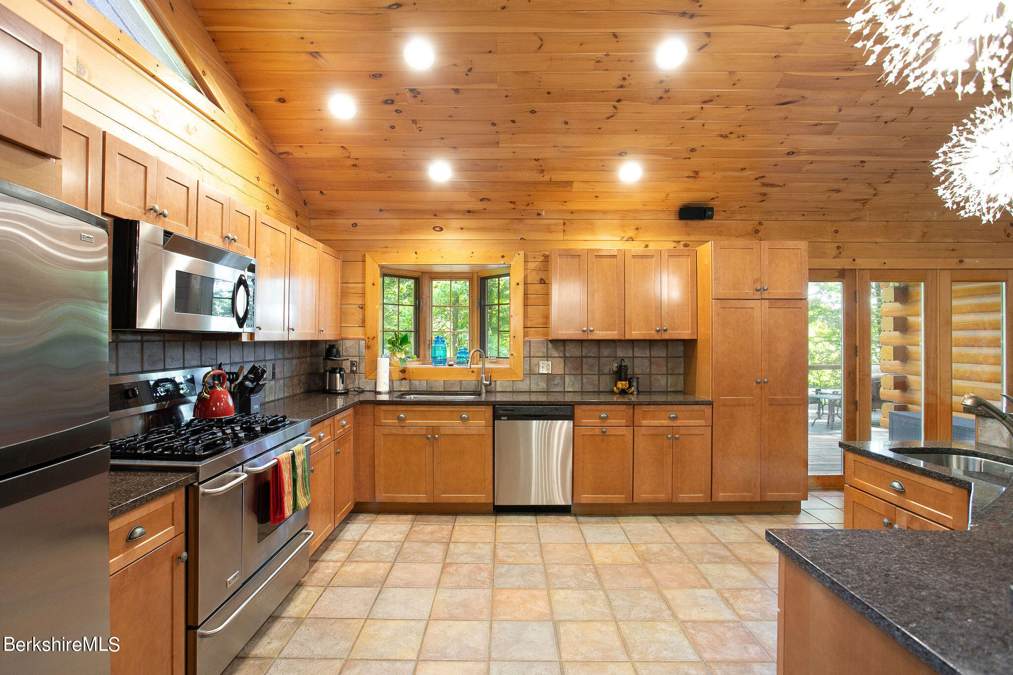 83 Main Road Monterey, MA 01230 - Photo 16 of 49 a kitchen with stainless steel appliances granite countertop a stove a sink and a microwave