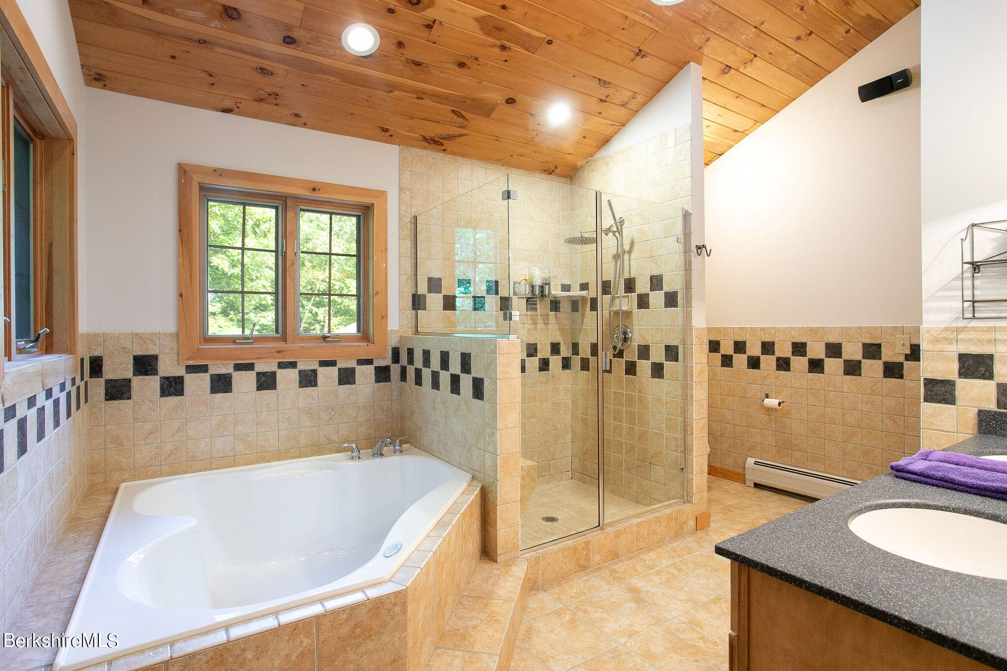 83 Main Road Monterey, MA 01230 - Photo 29 of 49 a bath tub sitting in a bathroom next to a window