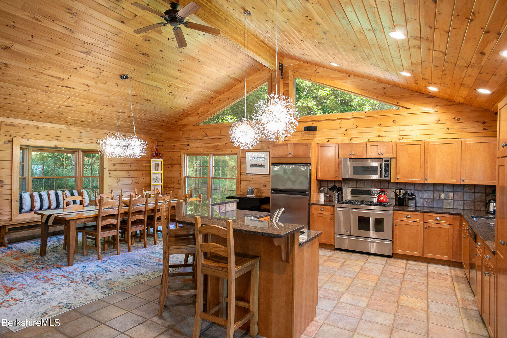 83 Main Road Monterey, MA 01230 - Photo 9 of 49 a kitchen with lots of counter top space and dining table