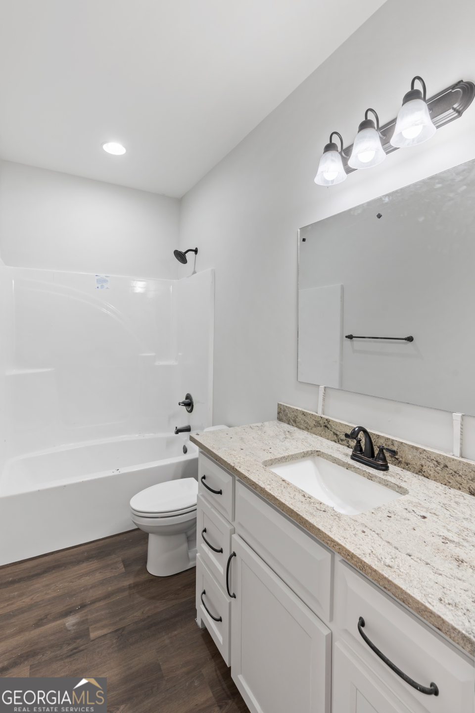 2830 Loch Laurel Road Valdosta, GA 31601 - Photo 18 of 40 a bathroom with a granite countertop toilet a sink and a mirror