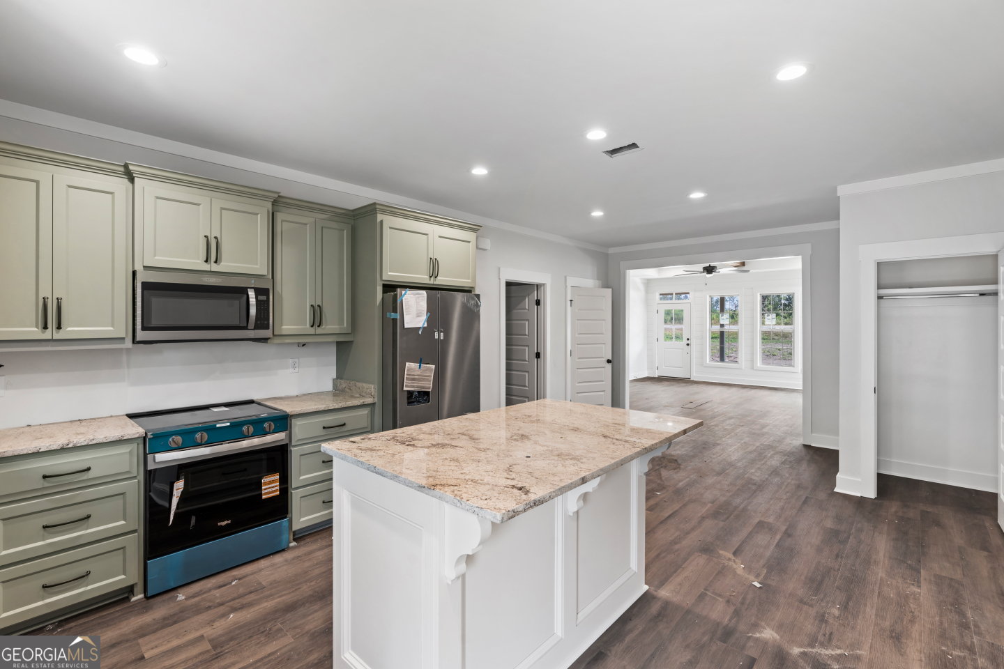 2830 Loch Laurel Road Valdosta, GA 31601 - Photo 6 of 40 a kitchen with stainless steel appliances kitchen island granite countertop a stove and a refrigerator