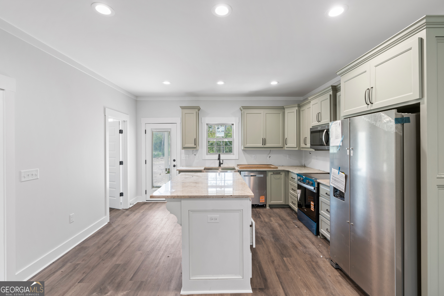 2830 Loch Laurel Road Valdosta, GA 31601 - Photo 7 of 40 a kitchen with white cabinets and stainless steel appliances
