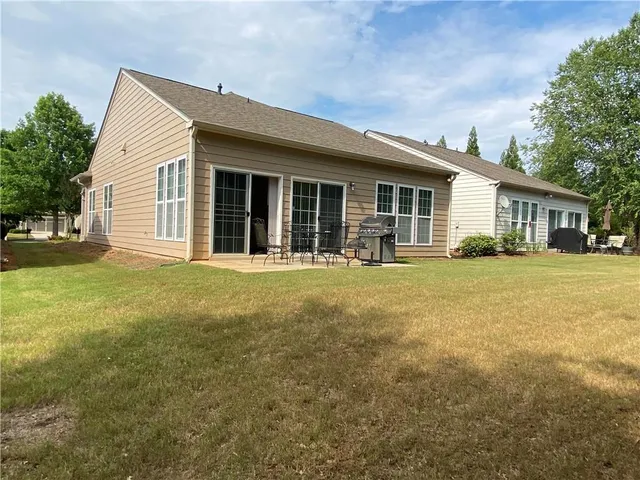 a view of yard with swimming pool and trees