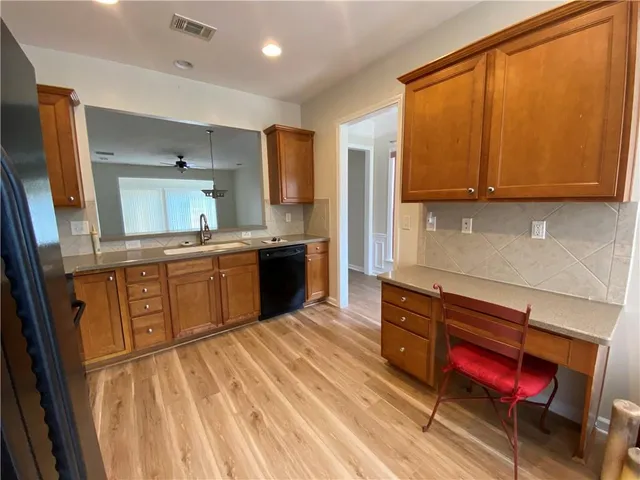 a kitchen with stainless steel appliances kitchen island granite countertop a sink stove and cabinets