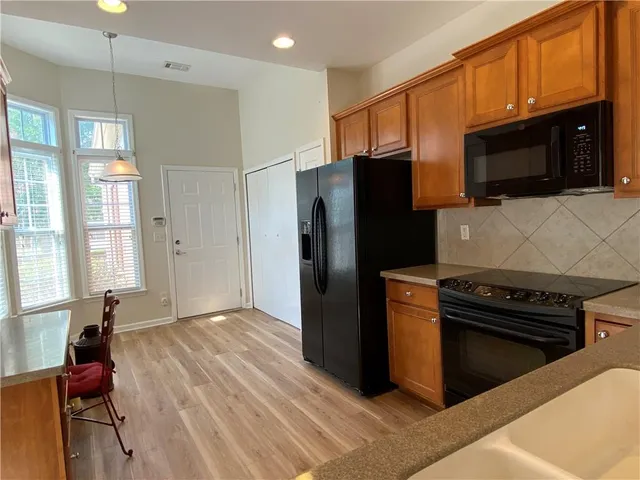 a kitchen with a refrigerator stove and microwave